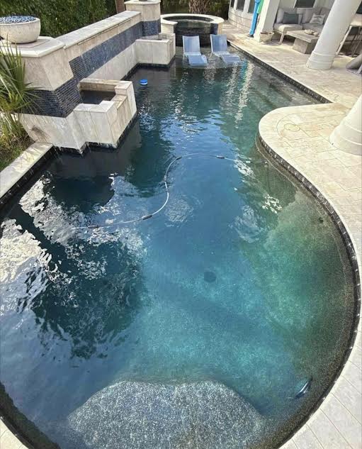 Custom backyard pool with spa and water feature