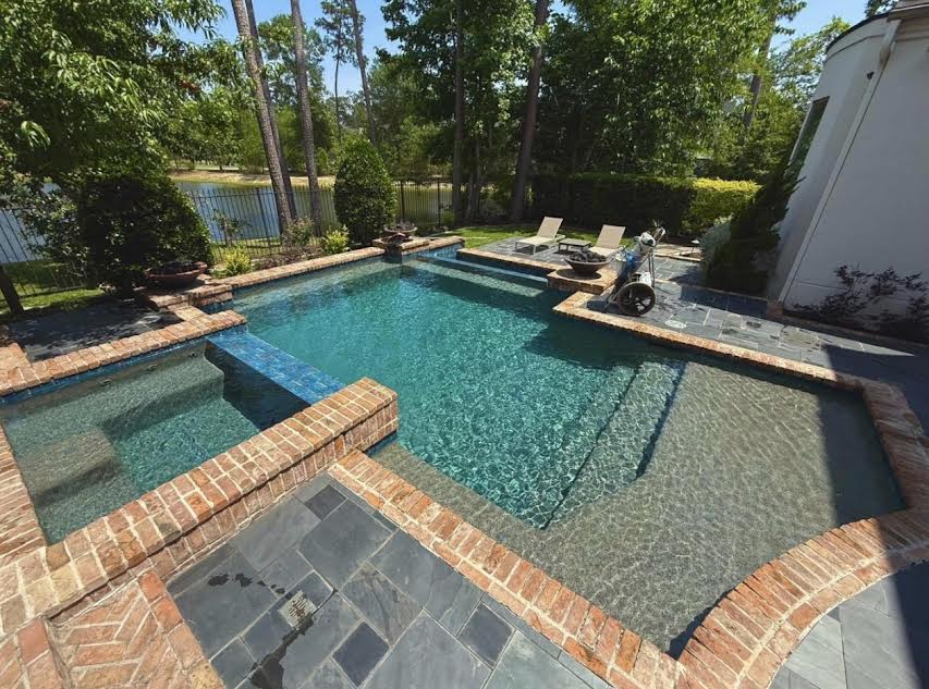 Geometric pool with brick coping and spa
